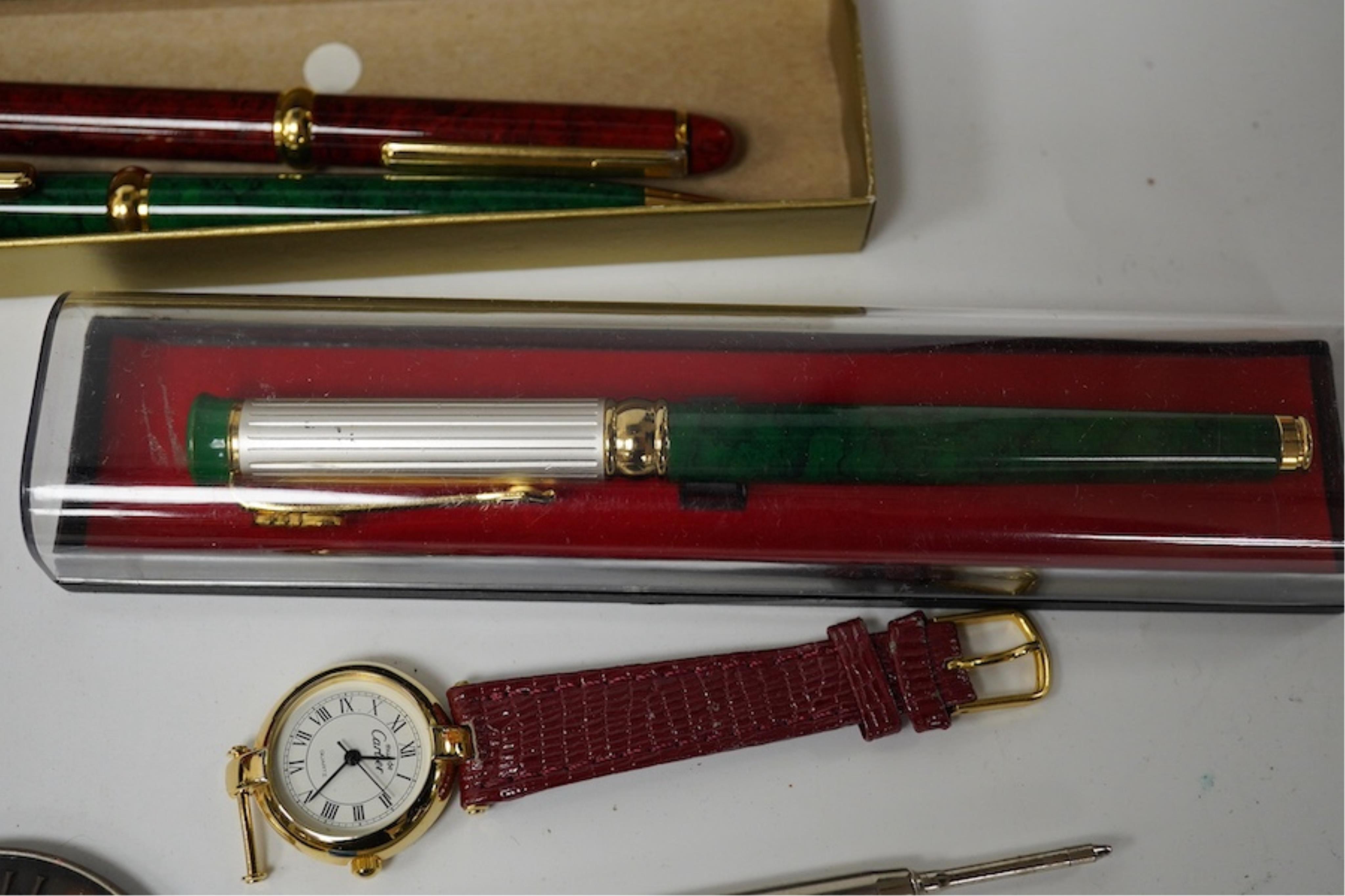 A collection of various pens, a ladies Must de Cartier wrist watch and a H.N. Ansell medal. Condition - varies